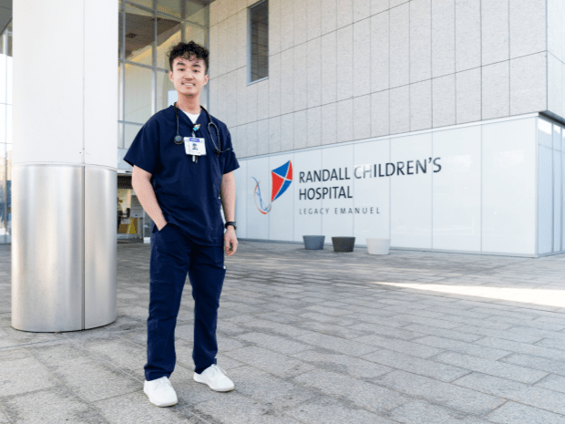 Image of Peter Tran posing in front of Randall Childrens Hospital