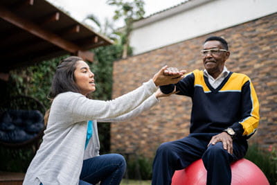 Rehab specialist uses balance and physical therapy for patient with Parkinson's disease