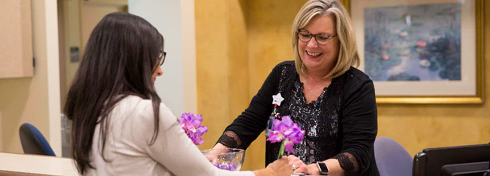 Patient checks in at front desk at Legacy Cancer Institute