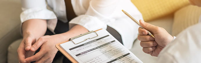 Gynecologist talking to patient about cervical cancer treatments