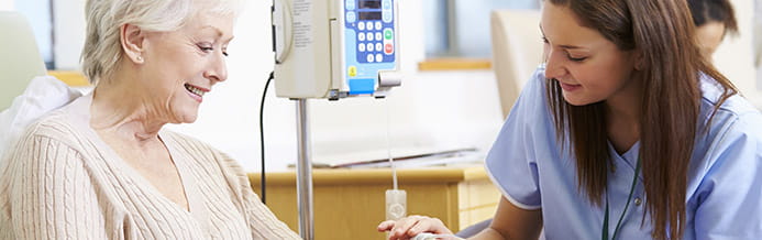 Nurse helping woman with chemotherapy