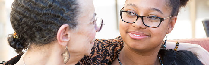 A friend hugs a vulvar cancer patient