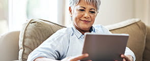 Older woman reading on an iPad