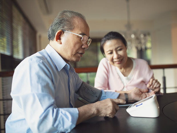 Senior couple checks blood pressure for stroke prevention
