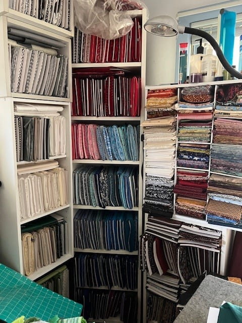 Shelves of quilts and fabric
