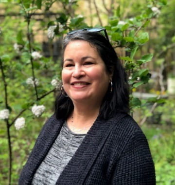 Professional photo of Leilani Van Hoomissen outdoors among green foliage - thumbnail image