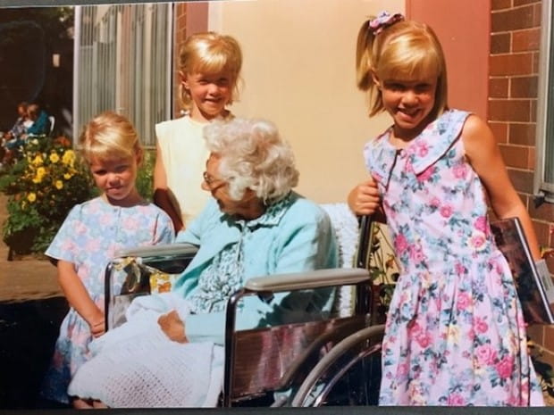 Grandma in wheelchair with three grandchildren