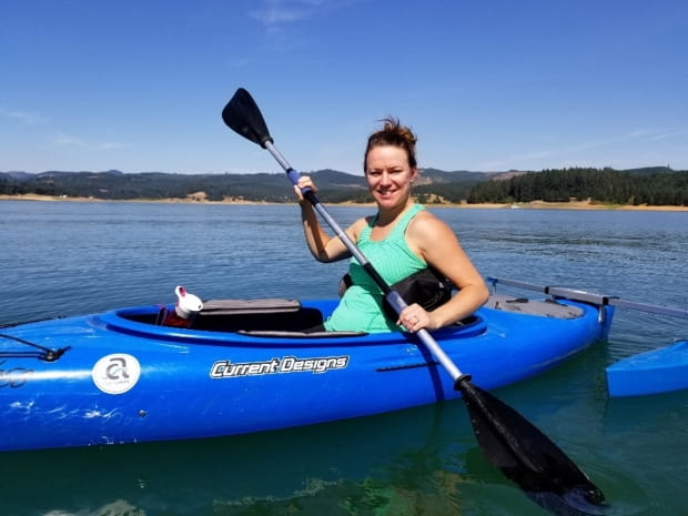 Photo of Joanna Adams kayaking out on a lake