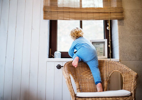 Toddler climbing toward window