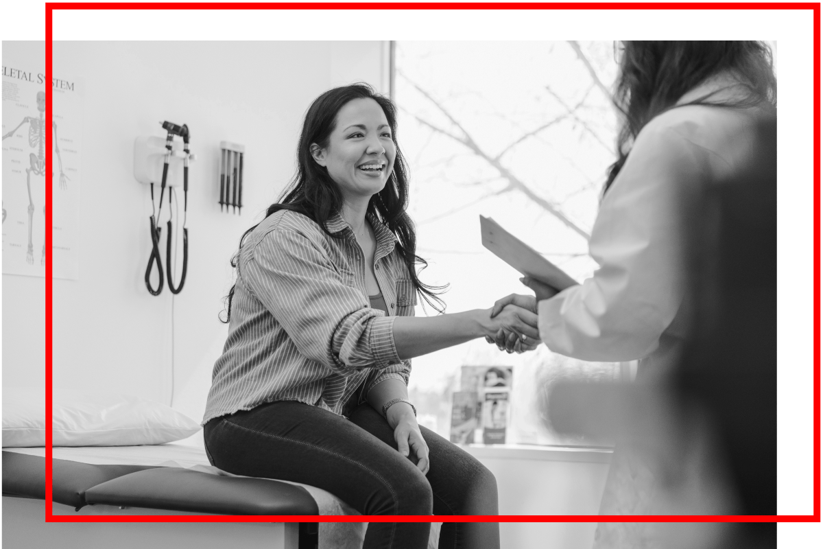 Female patient shaking hands with provider