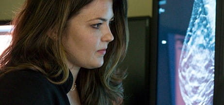 Legacy doctor looking at 3-D mammogram