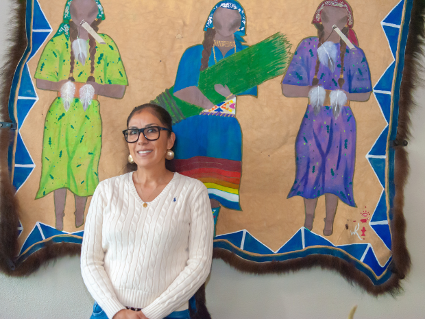 Loretta Guzman pictured in front of Native American artwork