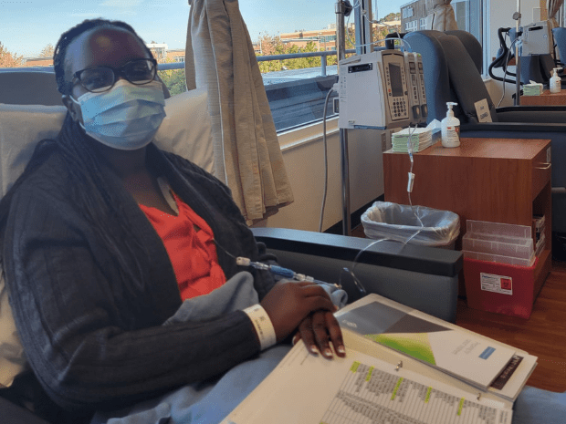 Keziah pictured sitting in recliner with some paperwork