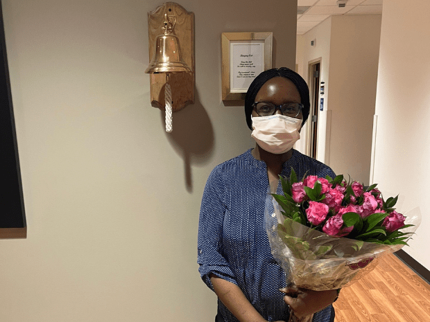 Keziah pictured with bell and flower bouquet