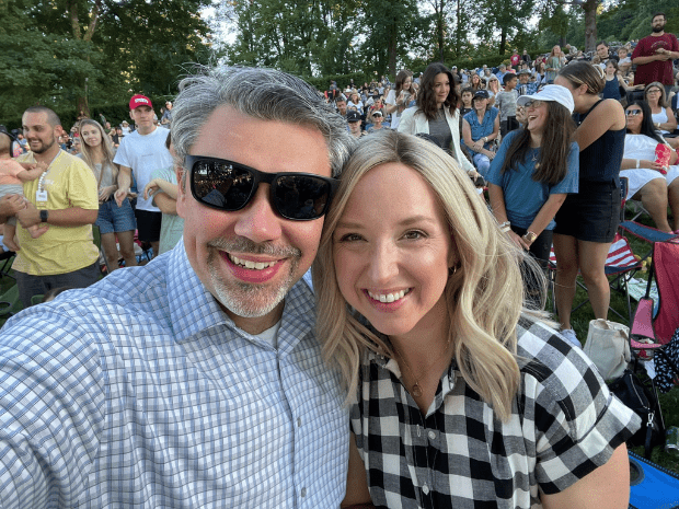 Photo of Nicole with husband at sporting event