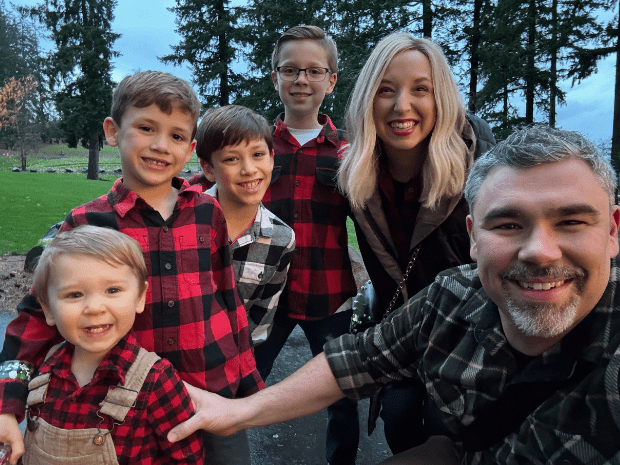 Photo of Nicole with family in matching flannel outfits